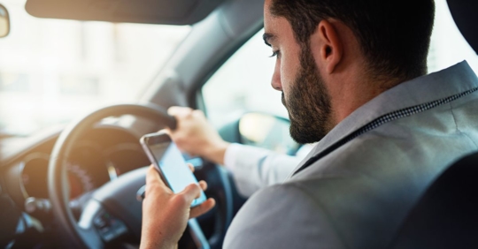 man texting and driving