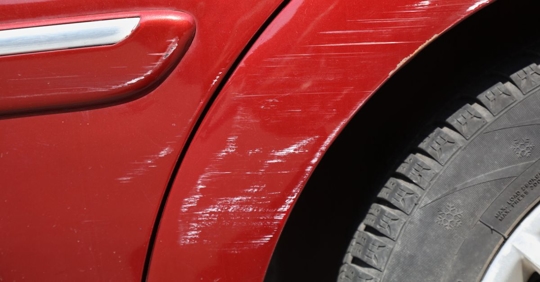 Car with scratches on it after a low-speed crash