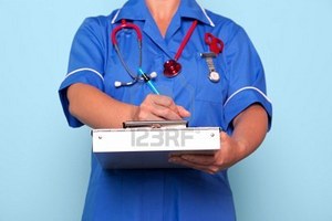 9969711-photo-of-a-nurse-in-uniform-holding-a-medical-report-folder-updating-some-patient-notes.jpg