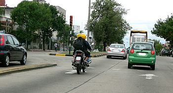 Motorcyclist driving on a road with other cars