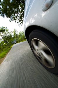 Close up of a car tire while the car is driving